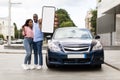 Happy black couple using showing smartphone with empty screen Royalty Free Stock Photo