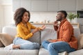 Cheerful Black Couple Talking Sitting On Couch In Living Room Royalty Free Stock Photo