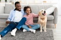 Cheerful black family spending time together with dog at home Royalty Free Stock Photo