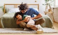 Cheerful black father tickling son at home Royalty Free Stock Photo