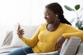 Black Female Listening Music Or Making Video Call On Smartphone At Home Royalty Free Stock Photo