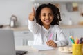 Cheerful black girl studying online, using laptop at home Royalty Free Stock Photo