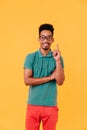 Cheerful black guy in big glasses expressing positive emotions. Indoor shot of stylish african man Royalty Free Stock Photo