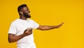 Cheerful black guy listening music in earphones on smartphone Royalty Free Stock Photo