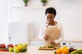 Cheerful Black Housewife Cooking Cutting Vegetables Preparing Dinner In Kitchen