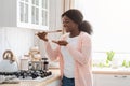 Cheerful Black Housewife Tasting Food While Cooking Healthy Lunch In Modern Kitchen Royalty Free Stock Photo