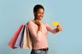 Cheerful Black Lady Demonstating Colorful Shopping Bags And Credit Card At Camera Royalty Free Stock Photo