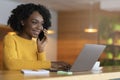 Cheerful black lady with laptop looking for job