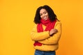 Cheerful Black Lady Wearing Winter Jacket Posing Over Yellow Background Royalty Free Stock Photo