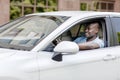 Handsome african american man driving car, shot from outside Royalty Free Stock Photo