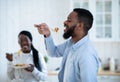 Cheerful Black Man Tasting Spaghetti While Having Lunch With Wife In Kitchen