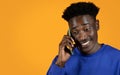 Cheerful black man using smartphone, have phone call Royalty Free Stock Photo