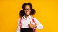 Cheerful Black School Girl Gesturing Thumbs-Up Posing Over Yellow Background Royalty Free Stock Photo