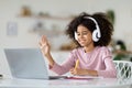 Cheerful black school girl having online class, home interior Royalty Free Stock Photo