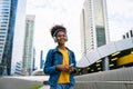 Cheerful black student girl wearing headset and using mobile smartphone Royalty Free Stock Photo