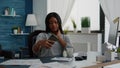 Cheerful black student smiling while taking selfie with smartphone sitting at desk Royalty Free Stock Photo