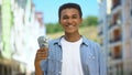 Cheerful black teen guy holding dollars bunch and smiling on camera first income Royalty Free Stock Photo