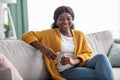Cheerful black woman drinking coffee at home Royalty Free Stock Photo