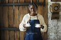 Cheerful black woman serving coffees