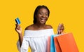 Cheerful Black Woman With Shopper Bags And Credit Card Over Yellow Background Royalty Free Stock Photo