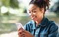 Cheerful Black Woman Using Mobile Phone And Earbuds Earphones Outdoor