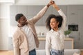 Cheerful black young couple dancing having fun at modern home Royalty Free Stock Photo