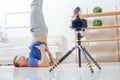 Cheerful blogger standing on his head and smiling to the camera