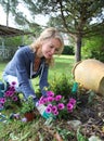 Cheerful blond woman gardening