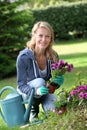 Cheerful blond woman gardening