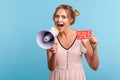 Cheerful blonde female with hair buns in beautiful dress paying attention announcing big sale yelling at loudspeaker, black Friday Royalty Free Stock Photo