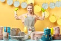 Cheerful blonde housewife in gray apron in green gloves showing biceps isolated Royalty Free Stock Photo