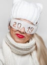 Cheerful blonde in safety glasses with the inscription ` 2019`