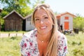 Cheerful blonde smiling woman front of fisherman wooden hut in Arcachon bay France