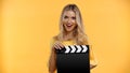 Cheerful blonde woman holding clapboard isolated Royalty Free Stock Photo