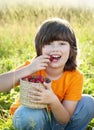 Cheerful boy with a basket of berries Royalty Free Stock Photo