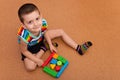 Cheerful boy building a block garage