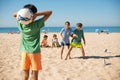 Cheerful boy friends playing football on beach Royalty Free Stock Photo