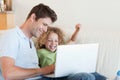 Cheerful boy and his father using a laptop Royalty Free Stock Photo