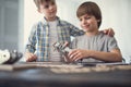 Cheerful boy holding toy car while his brother standing near Royalty Free Stock Photo