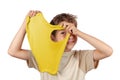 Cheerful boy holding a yellow slime and looking through its hole