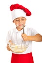 Cheerful boy mixing dough