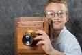 Cheerful boy retro photographer with vintage wooden camera Royalty Free Stock Photo