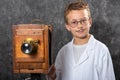 Cheerful boy retro photographer with vintage wooden camera Royalty Free Stock Photo