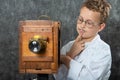 Cheerful boy retro photographer with vintage wooden camera Royalty Free Stock Photo