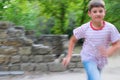 Cheerful boy running in the park Royalty Free Stock Photo