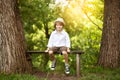 Cheerful boy sitting on a bench Royalty Free Stock Photo