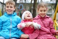 Cheerful boy and two girls in bright jackets on Royalty Free Stock Photo