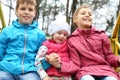 Cheerful boy and two girls in bright jackets on Royalty Free Stock Photo