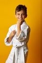 Cheerful boy in white kimono smiling at camera Royalty Free Stock Photo
