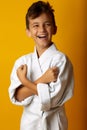 Cheerful boy in white kimono smiling at camera Royalty Free Stock Photo